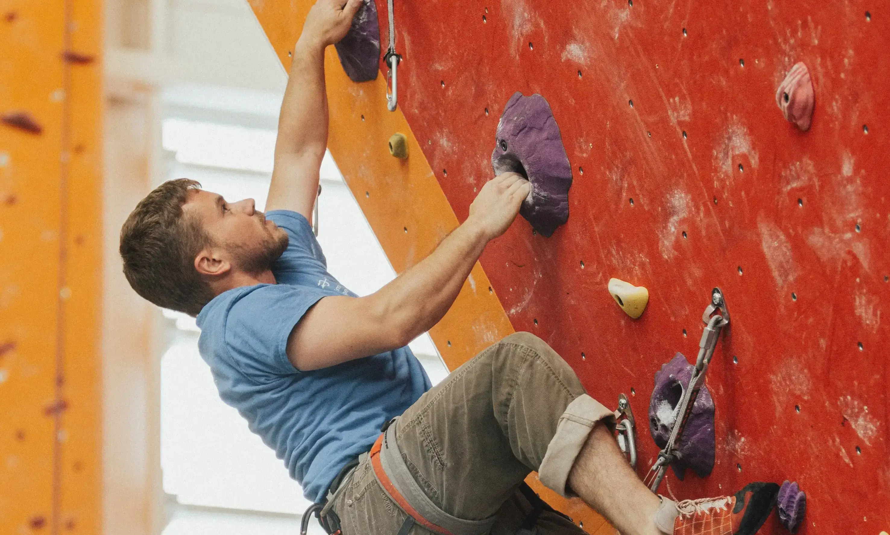 A man climbing a wall and looking up